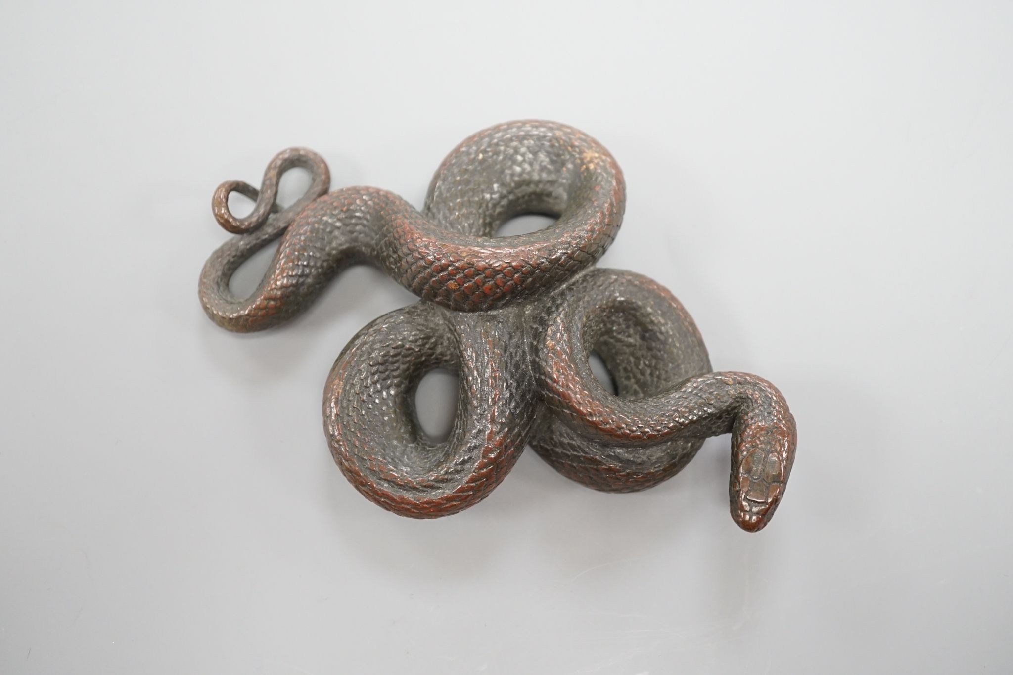 A European cast bronze figure of a snake, 12 cms wide.